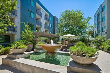 Mingle: courtyard with outdoor fireplace, water feature, and bbq grills